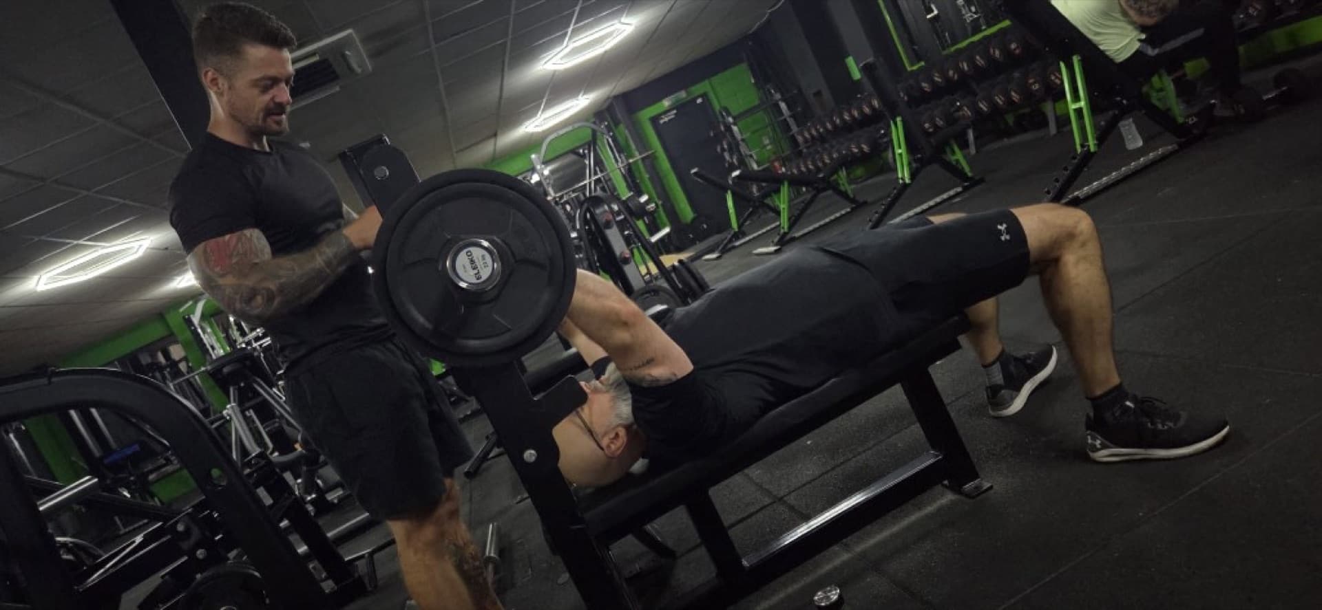 Declan spotting a client during a bench press